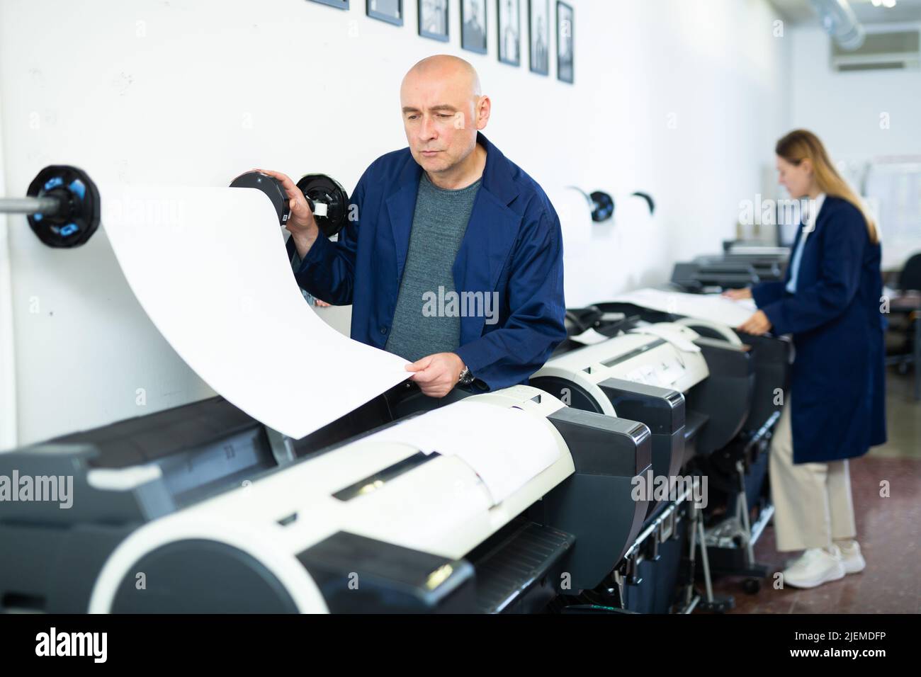 Man working in publishing facility Stock Photo