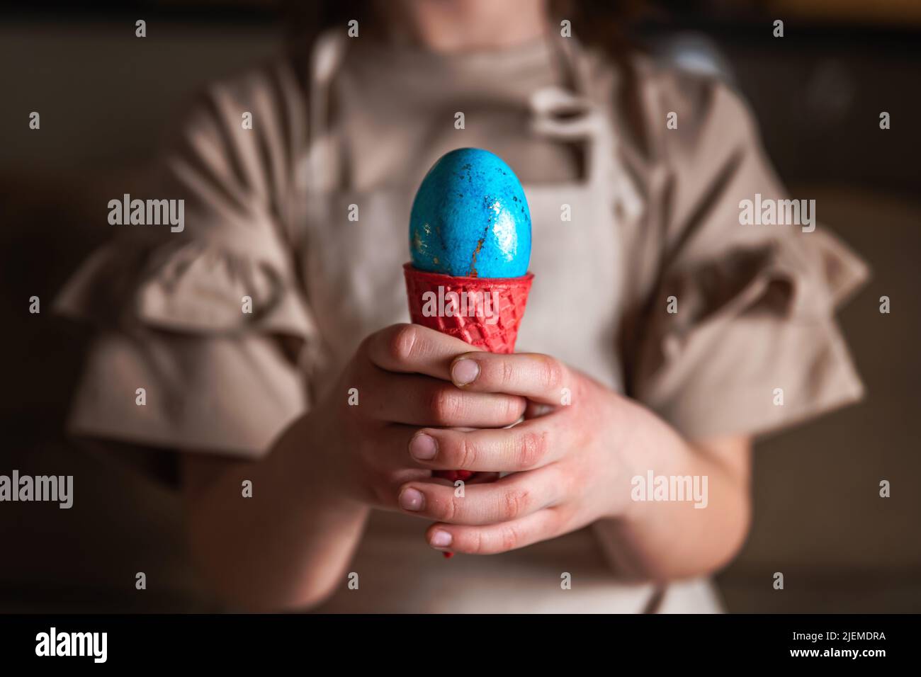 girl holding an Easter egg in a colored ice cream cone Stock Photo Alamy