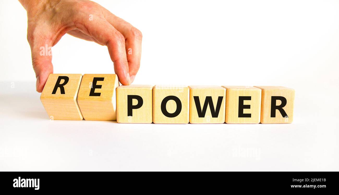 Power or repower symbol. Businessman turns wooden cubes and changes concept words Power to Repower. Beautiful white table white background. Business e Stock Photo