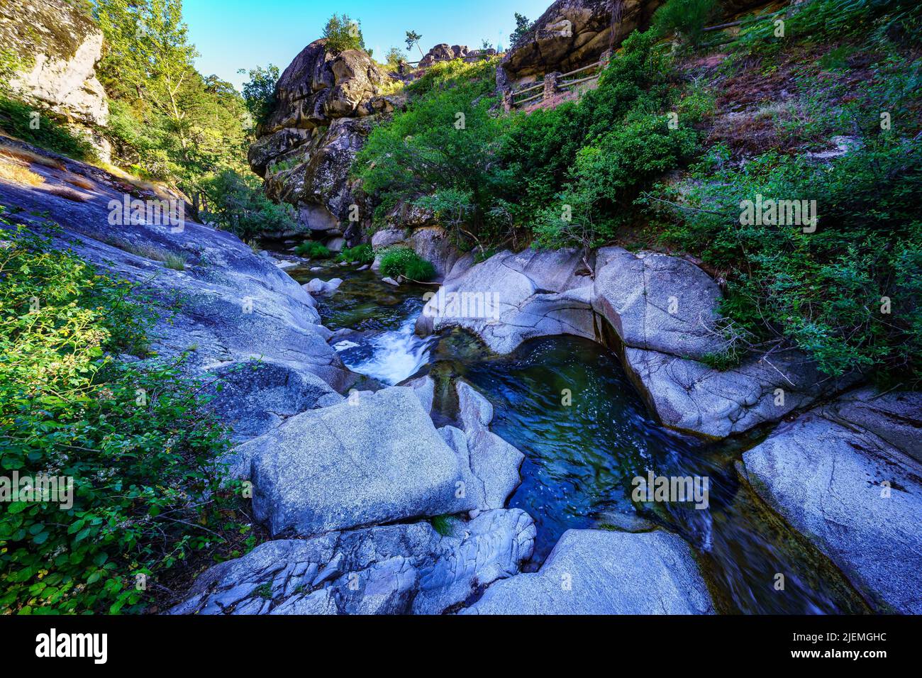 Small stream between rocks at dawn on a summer day. Navacerrada. Stock Photo