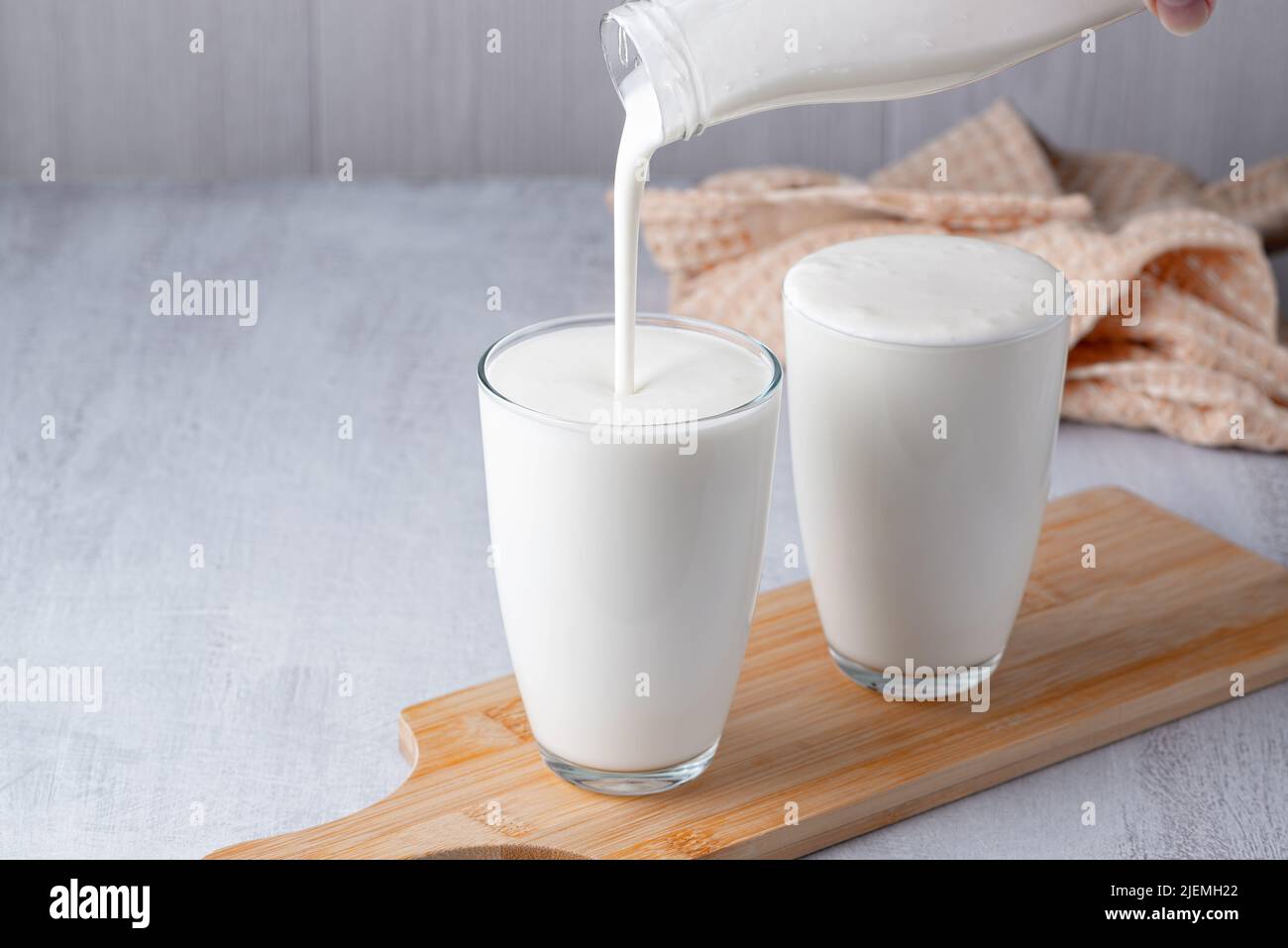 Pouring homemade kefir, buttermilk or yogurt with probiotics Stock