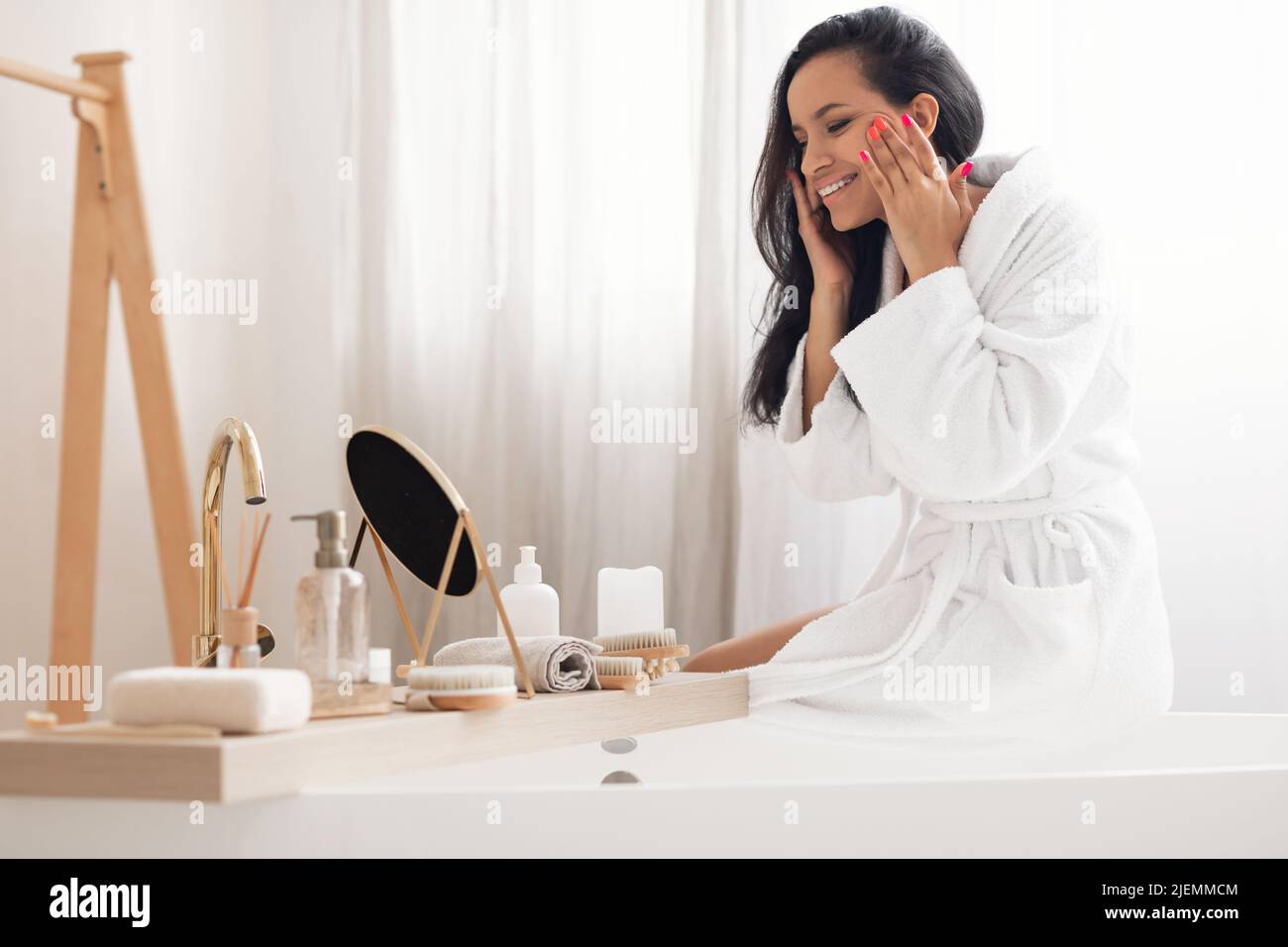 Happy African American Female Massaging Face Enjoying Skincare In ...