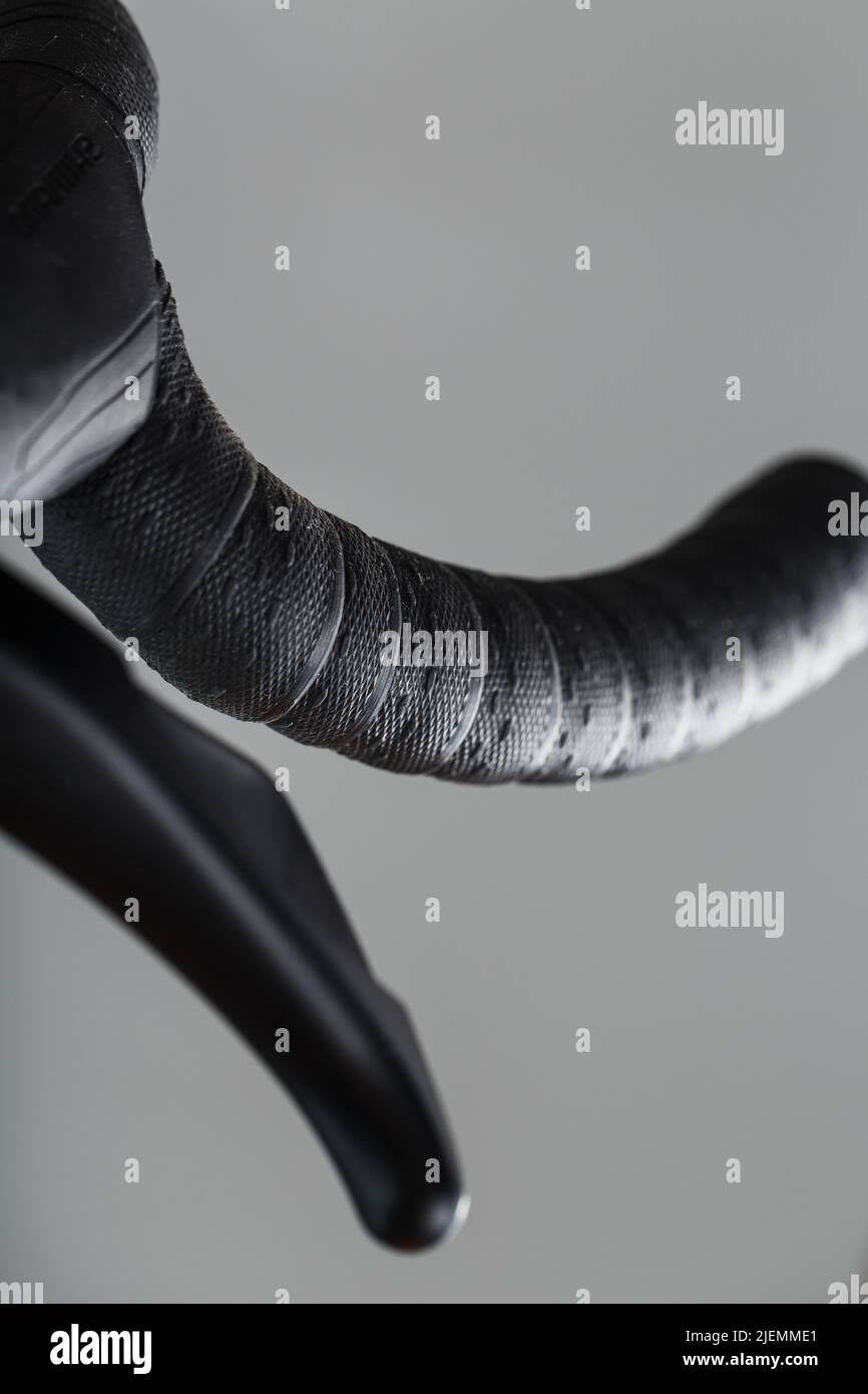 Steering wheel winding with brake handle of a road bike close-up on a gray background Stock Photo