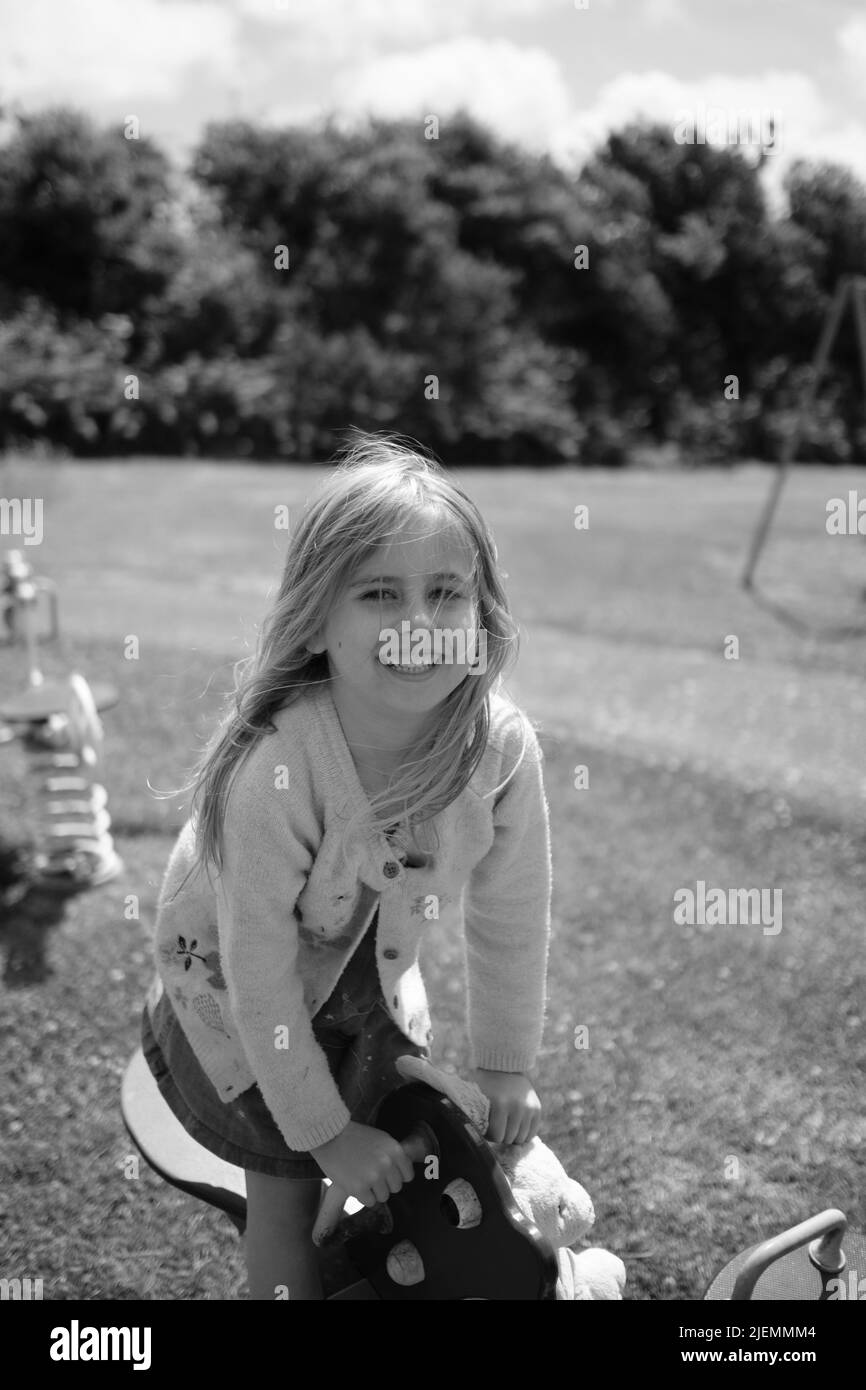 Girl, aged 5, playing in the park Stock Photo