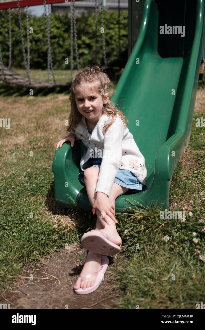 Girl, aged 5, playing in the park Stock Photo