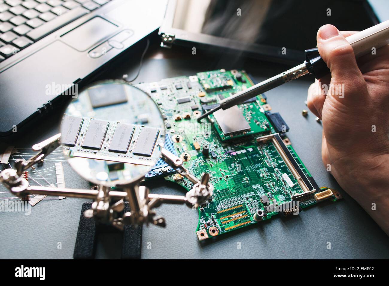 Technician repair (soldering iron) laptop computer Stock Photo Alamy