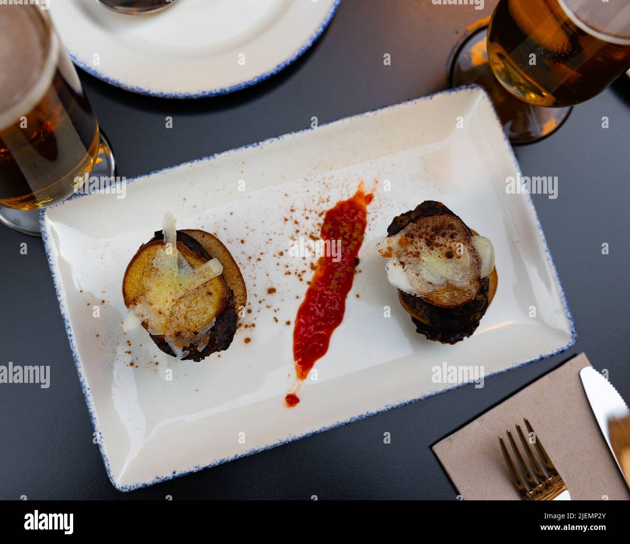 Spanish timbale of morcilla with caramelized pears and cheese Stock