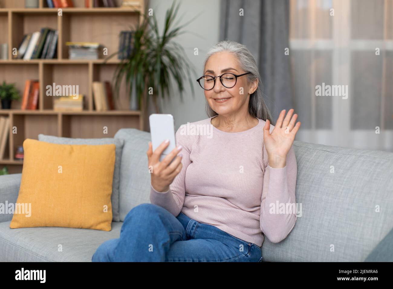 Old woman sitting alone sofa hi-res stock photography and images - Alamy