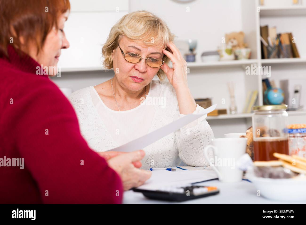 pensioners females with utilities bills Stock Photo