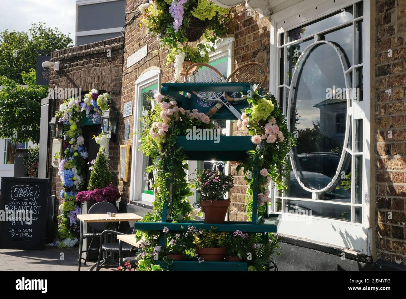 London, UK, 27th June, 2022. Tennis themed shop displays and in Wimbledon Village and the main town centre can be seen as visitors are welcomed in the area as the 2022 tennis tournament gets underway. This year the ground returns to full capacity after the Covid pandemic. Credit: Eleventh Hour Photography/Alamy Live News Stock Photo