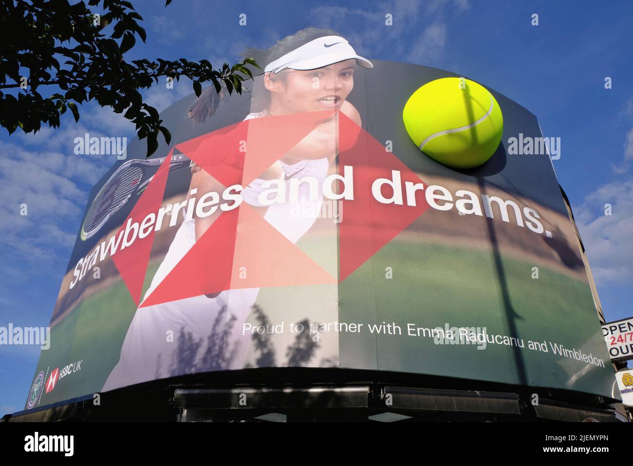 London, UK, 27th June, 2022. An advertisment featuring tennis star Emma Radacanu. Tennis themed shop displays and in Wimbledon Village and the main town centre as the 2022 tournament begins. This year the ground returns to full capacity after the Covid pandemic. Credit: Eleventh Hour Photography/Alamy Live News Stock Photo