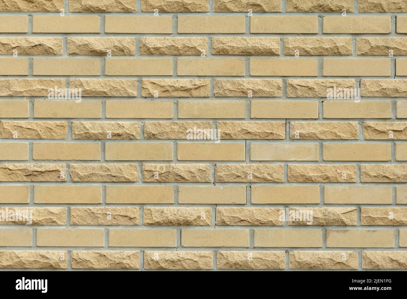 Solid yellow and beige brick wall. Brick background. Stock Photo