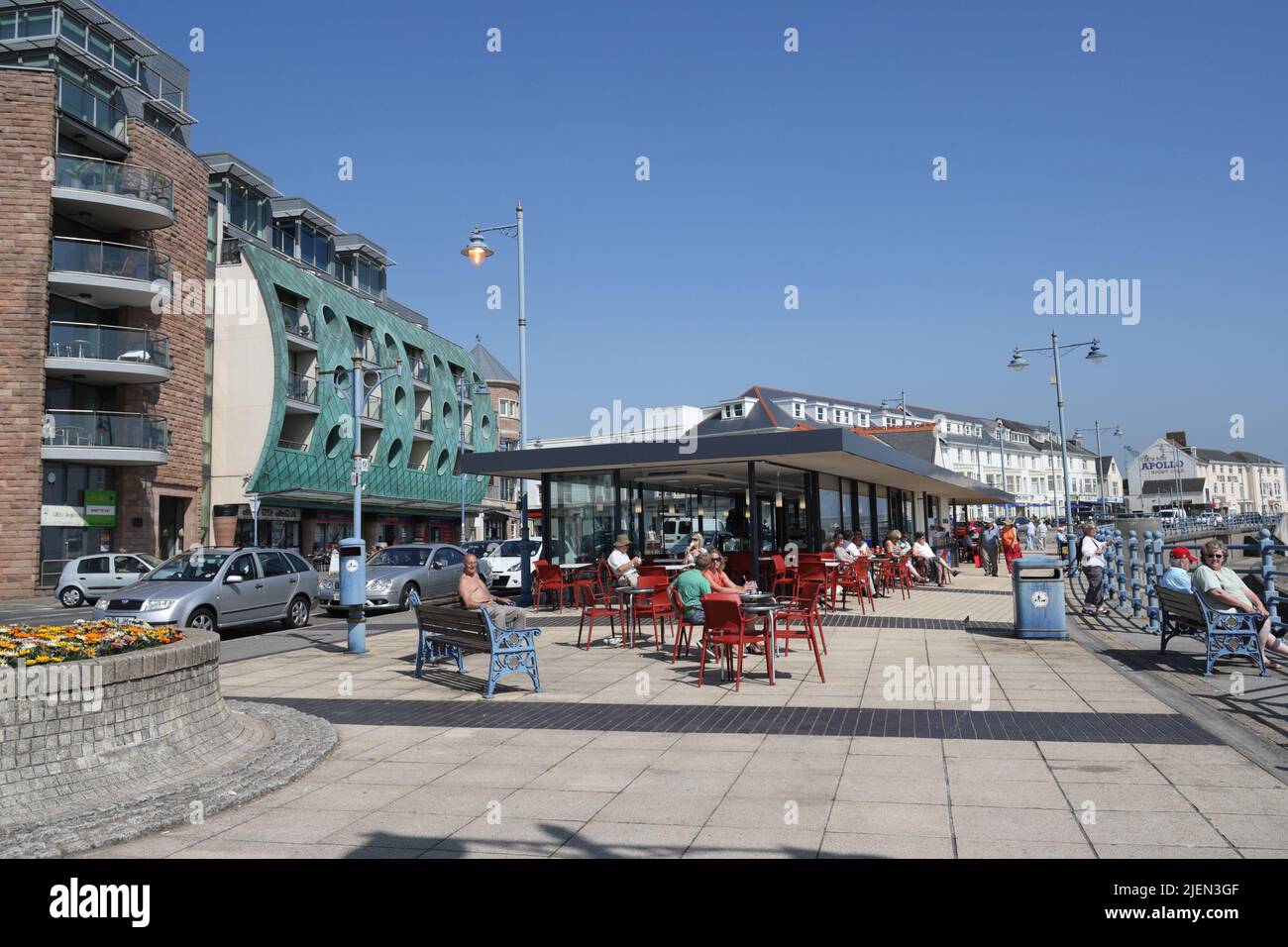 The promenade at Porthcawl in Wales, Welsh seaside resort. People sitting by street cafe. Wales coast coastline staycation UK Stock Photo