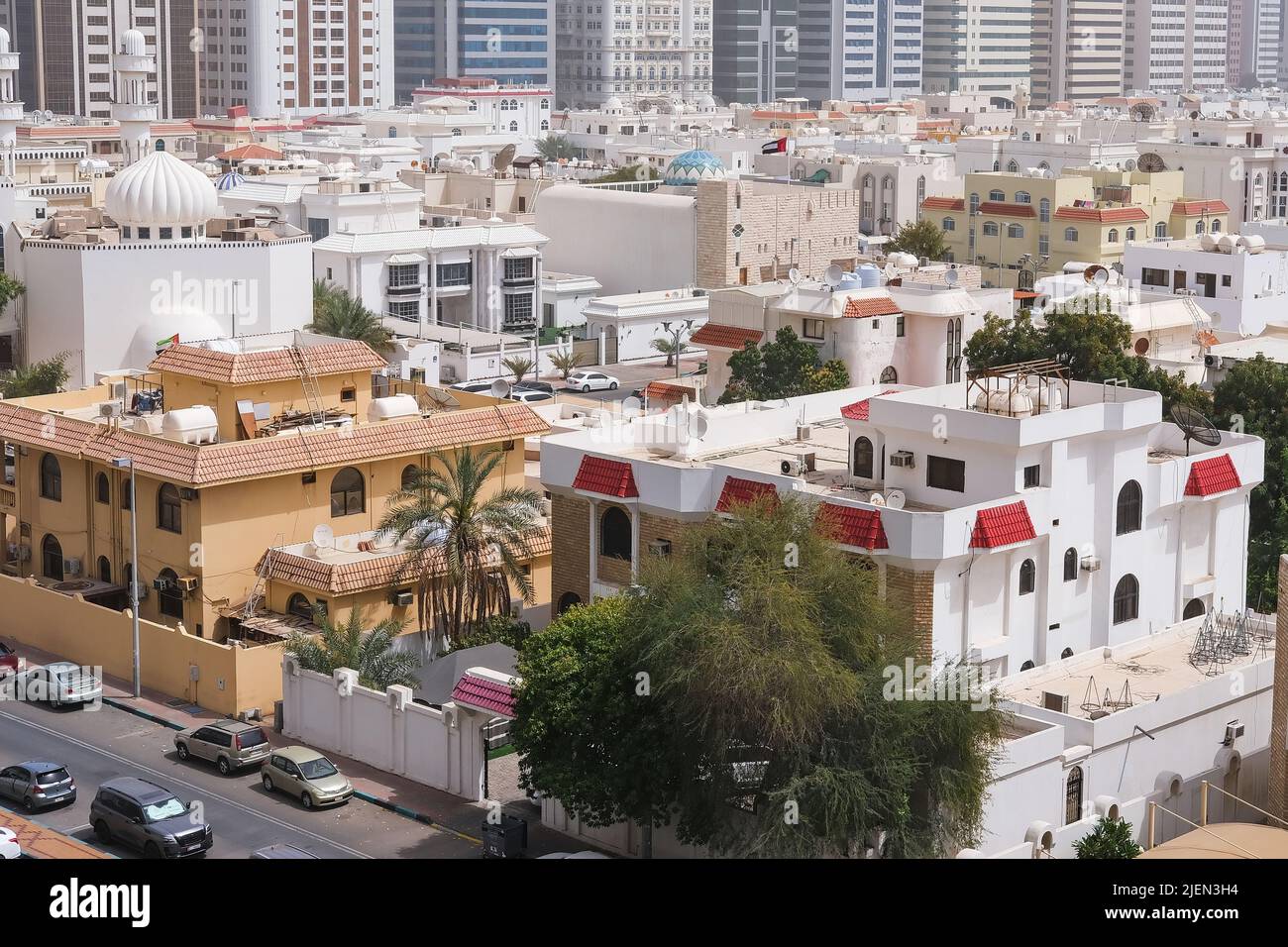 Villas residential area of Abu Dhabi with modern tower blocks in background. Modern middle eastern urban architecture. Stock Photo