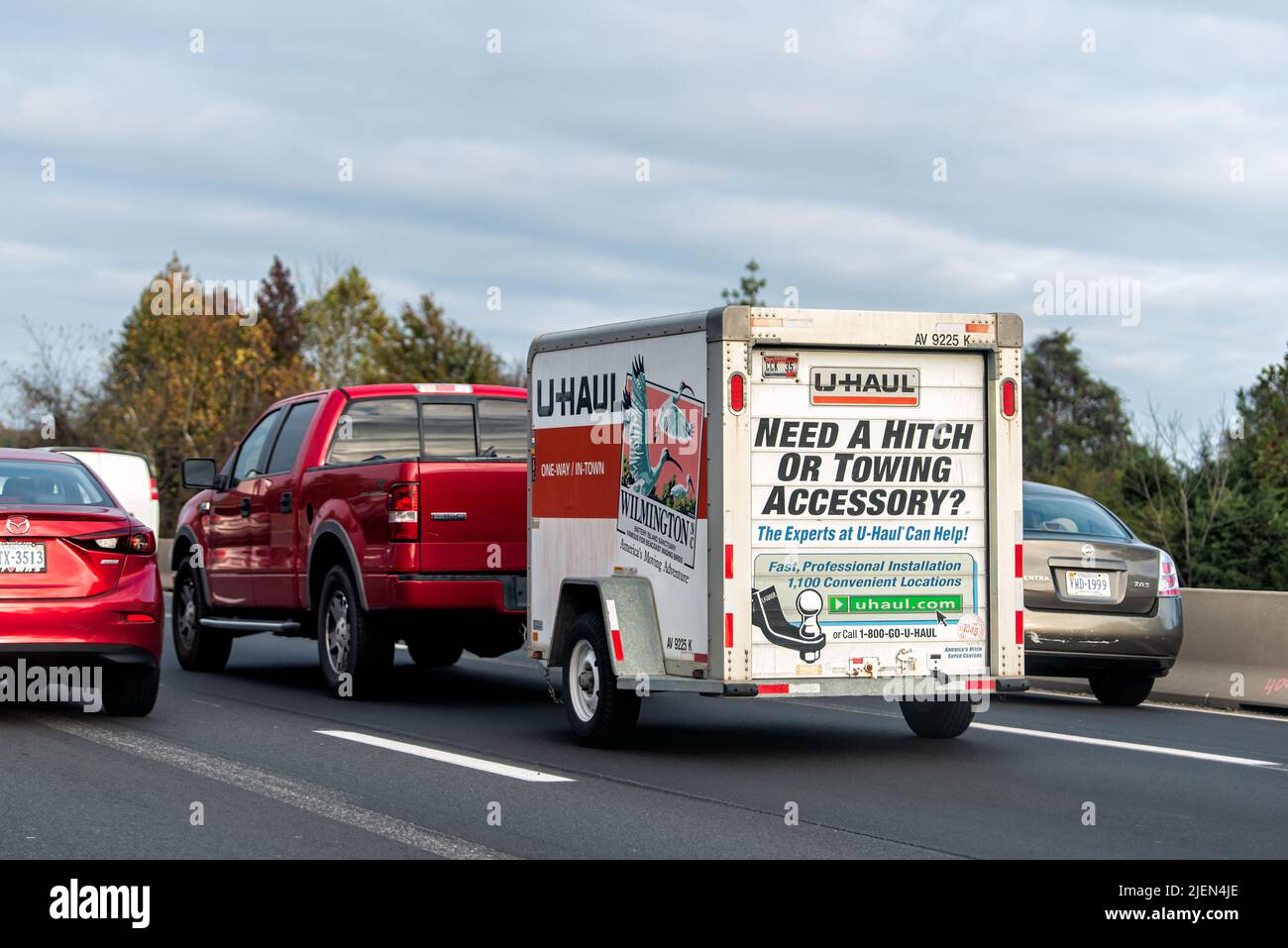Gainesville, USA - October 27, 2020: U-Haul trailer attached to Ford F-150 pickup truck with cars in traffic relocating moving from North Carolina to Stock Photo