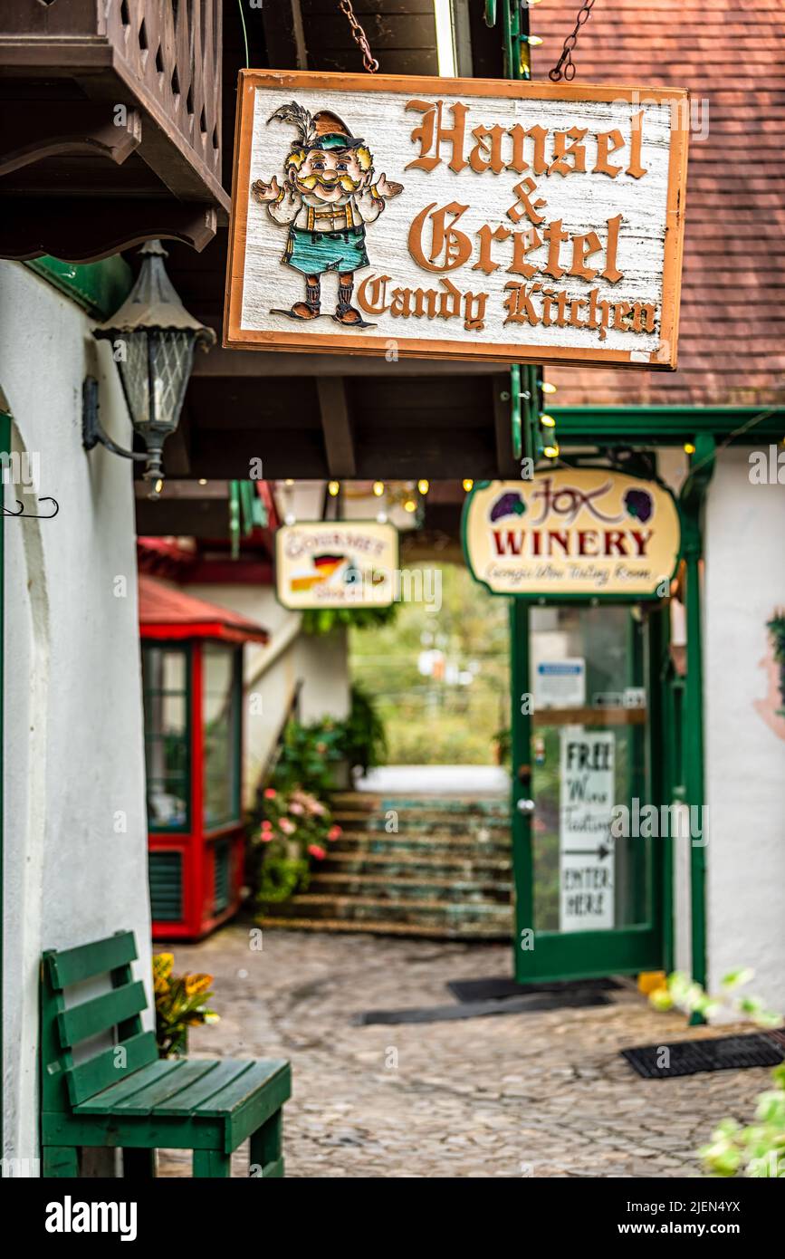 Helen, USA - October 5, 2021: Bavarian village of Helen, Georgia street with sign entrance for Hansel and Gretel candy kitchen narrow alleyway traditi Stock Photo