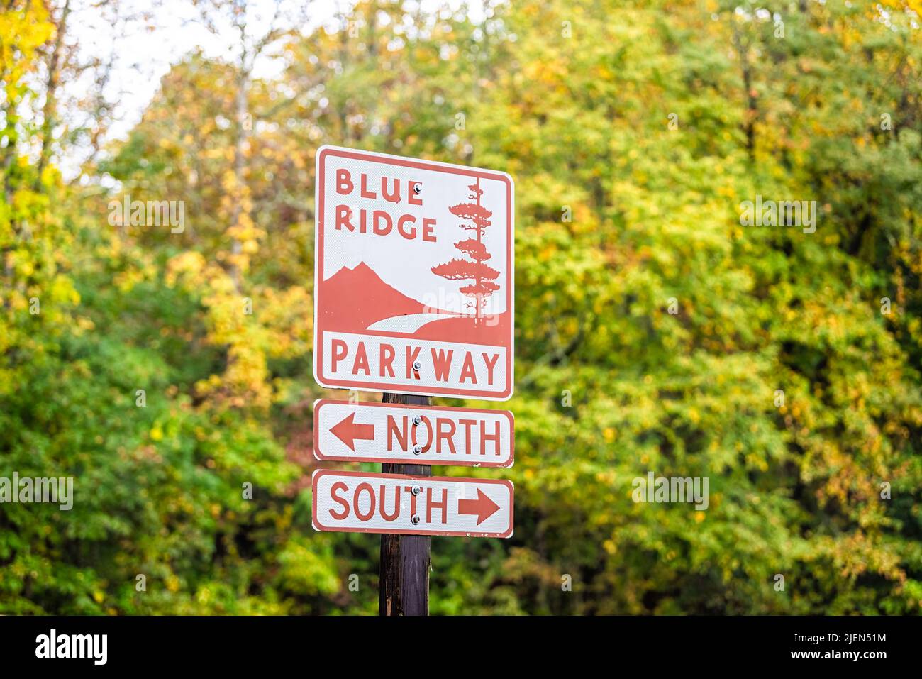Laurel Springs, USA - October 6, 2021: Blue Ridge mountains national park in autumn fall with yellow green foliage on trees and sign for parkway road Stock Photo