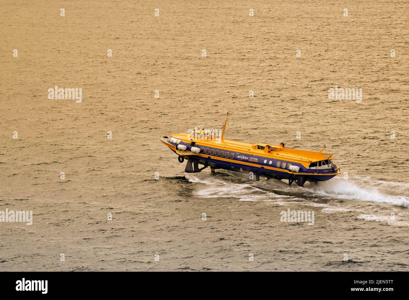 Piraeus, Athens, Greece - June 2022: High speed hydrofoil ferry after leaving the port of Piraeus in evening light Stock Photo