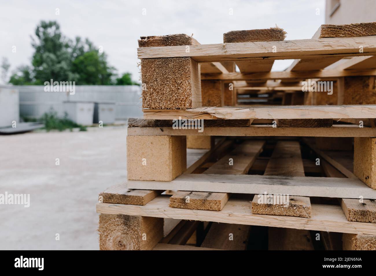 Wooden pallets lie on top of each other on the street. Close up Stock Photo