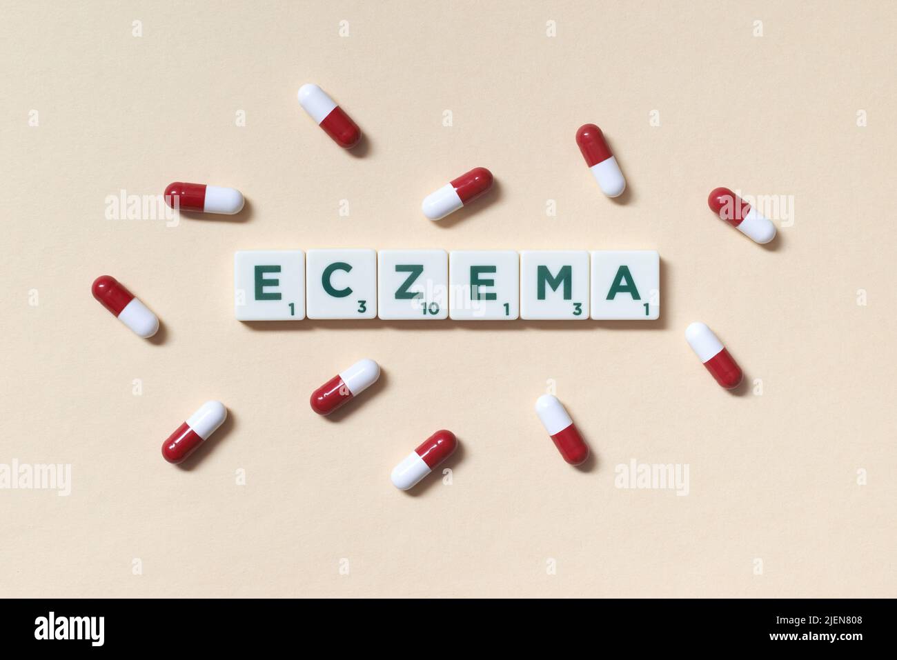 Eczema formed of scrabble blocks and pharmaceutical pills. Stock Photo