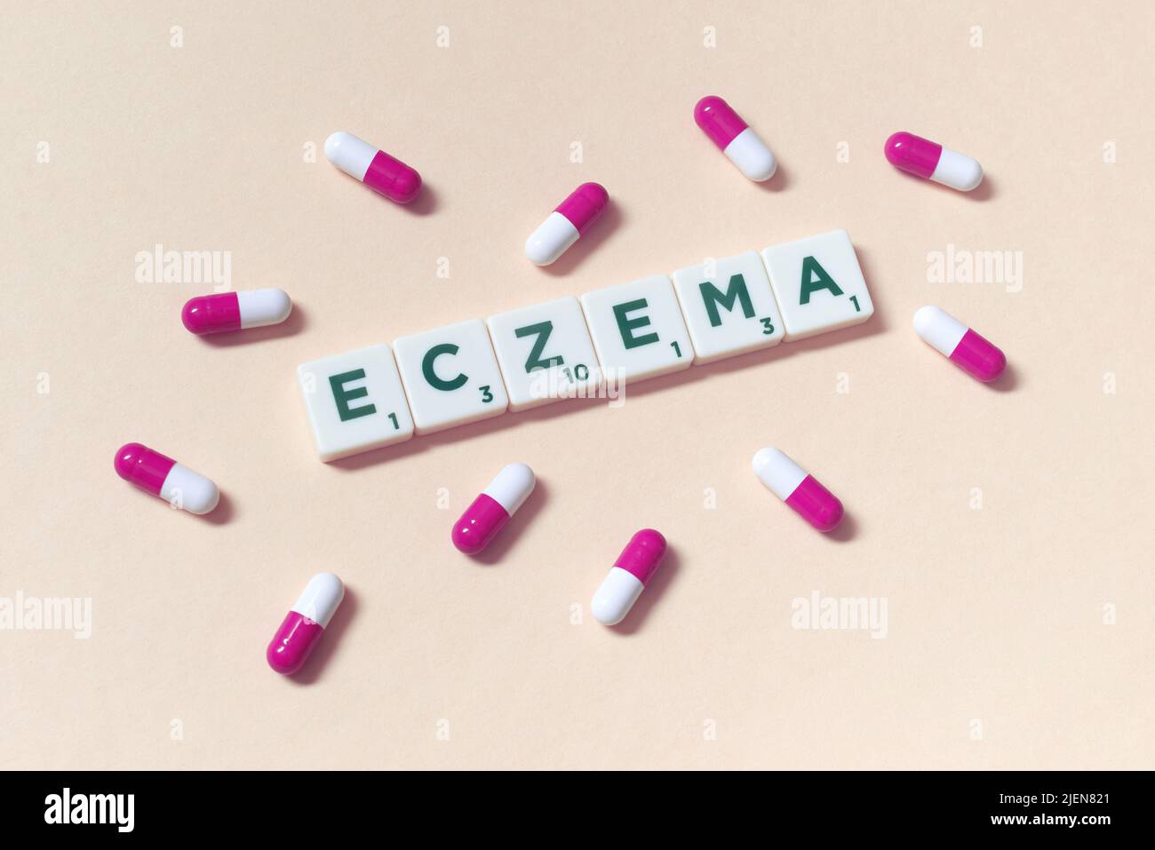 Eczema formed of scrabble tiles and pharmaceutical capsules. Stock Photo
