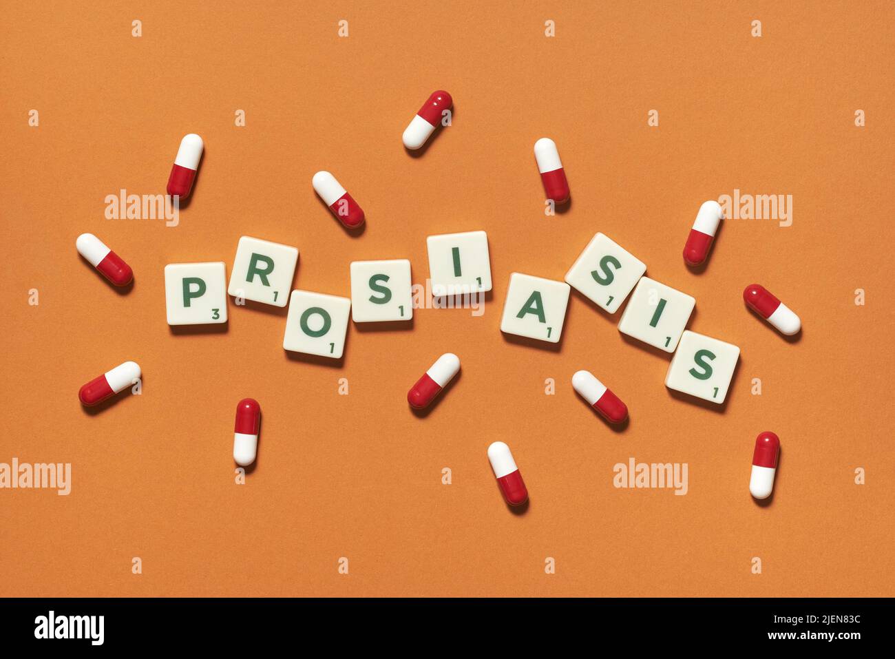 Psoriasis formed of scrabble blocks and pharmaceutical pills. Stock Photo