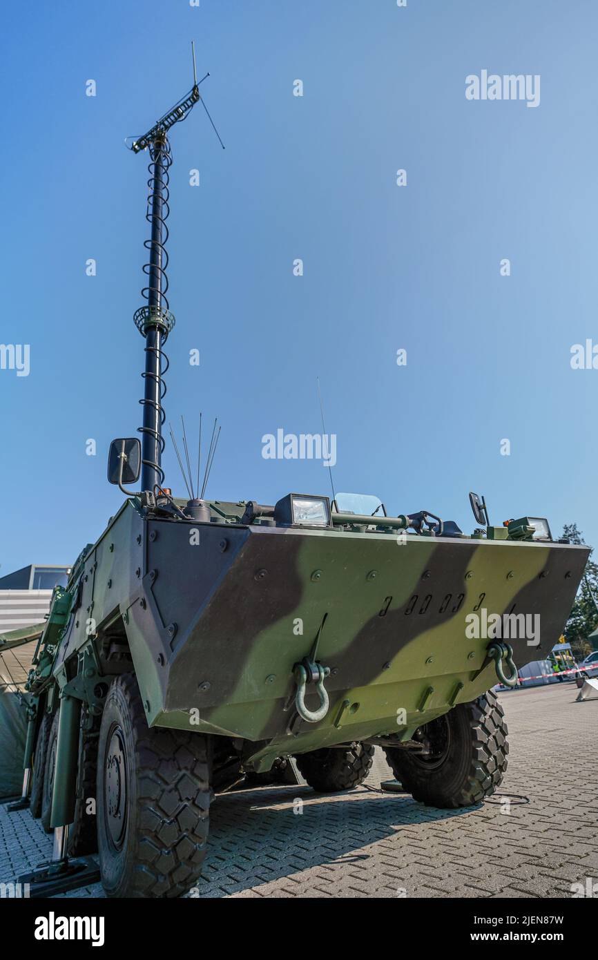 Armoured military vehicle, with tall communication mast, antenna at top Stock Photo