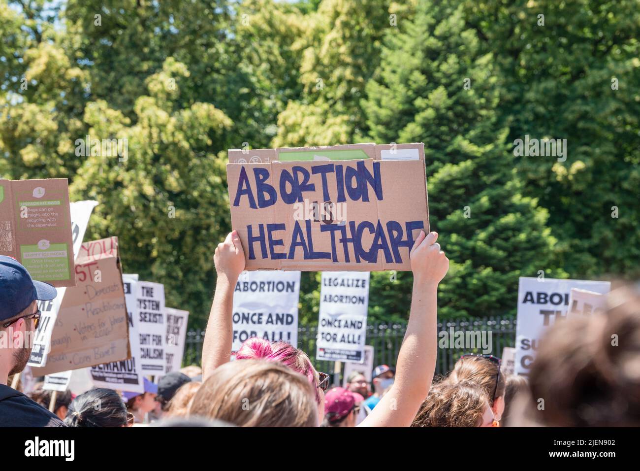 Protests holding pro-abortion signs at demonstration in response to the Supreme Court ruling overturning Roe v. Wade at the Massachusetts State House Stock Photo