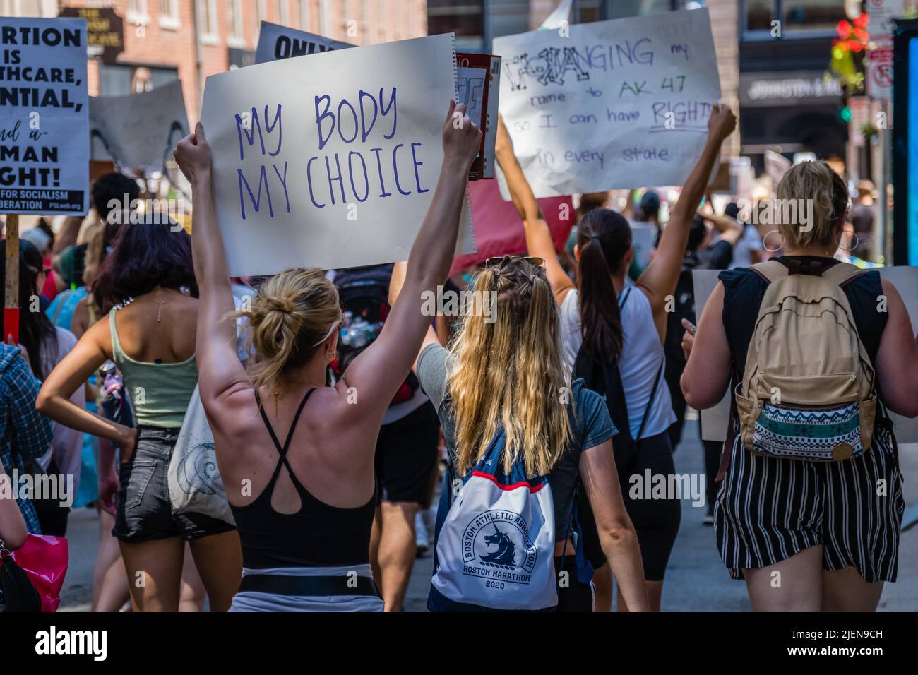 Protests holding pro-abortion signs at demonstration in response to the Supreme Court ruling overturning Roe v. Wade at the Massachusetts State House Stock Photo