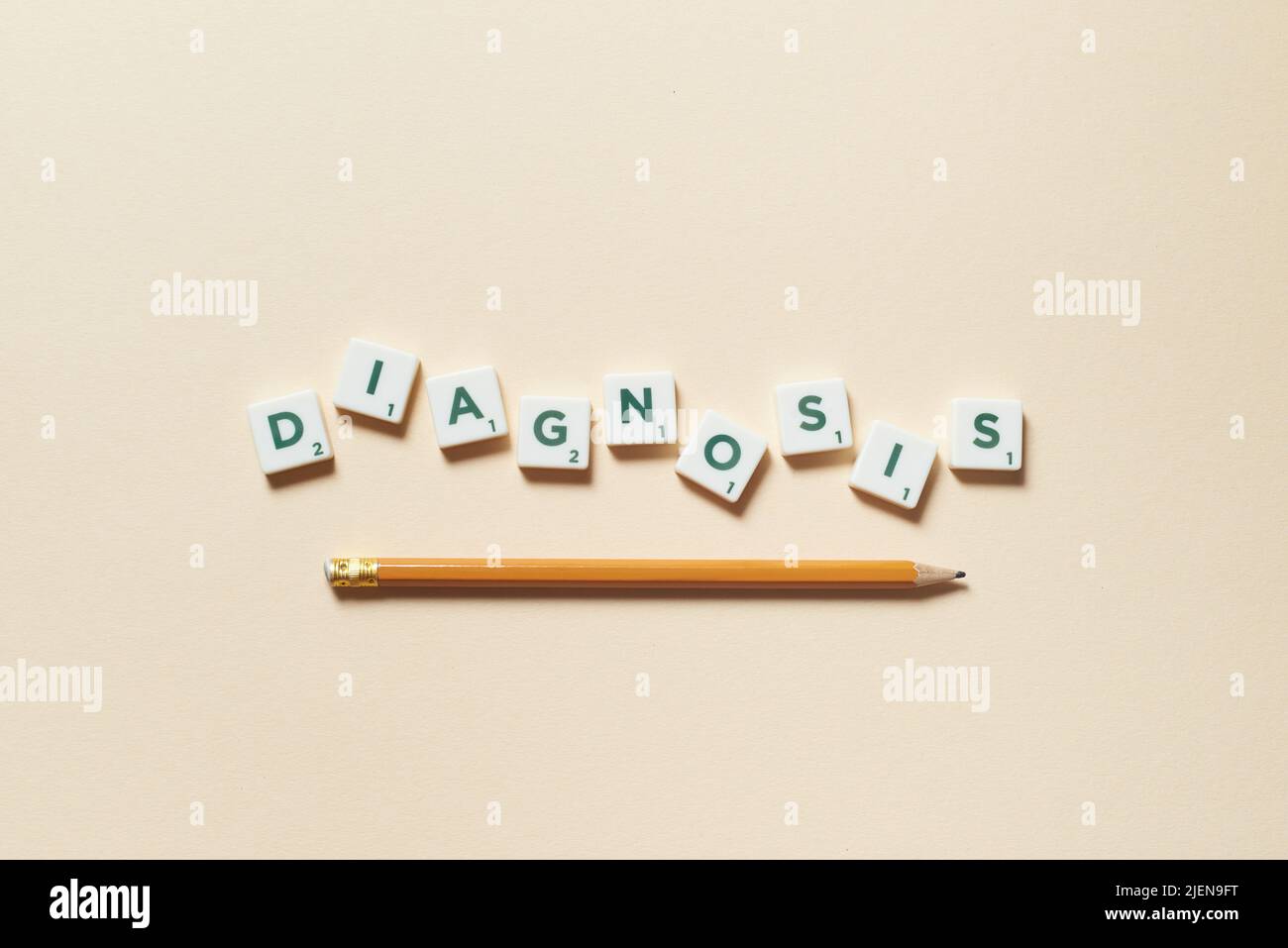 Diagnosis formed of scrabble tiles and pencil Stock Photo Alamy