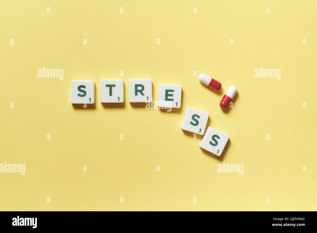 Stress formed of scrabble tiles and pharmaceutical pills Stock Photo
