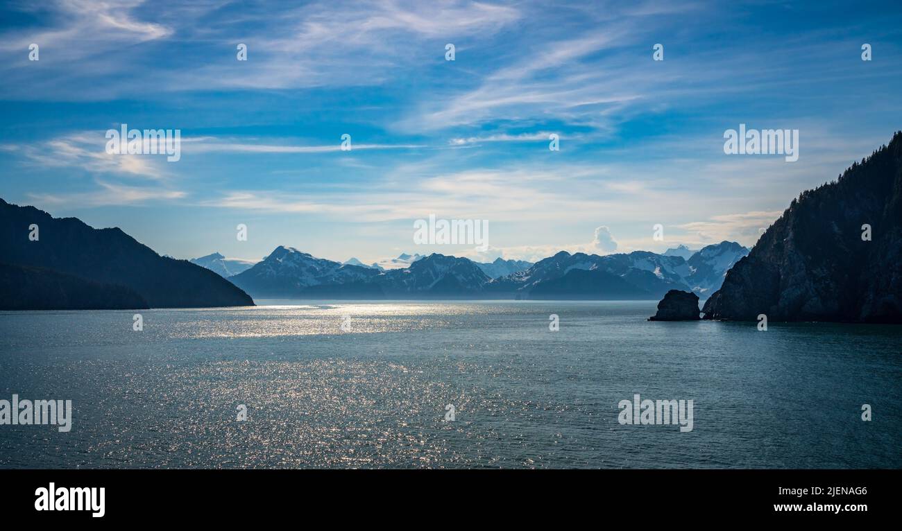 Wide panorama of snow covered peaks of the mountains overlooking Resurrection Bay near Seward in Alaska Stock Photo