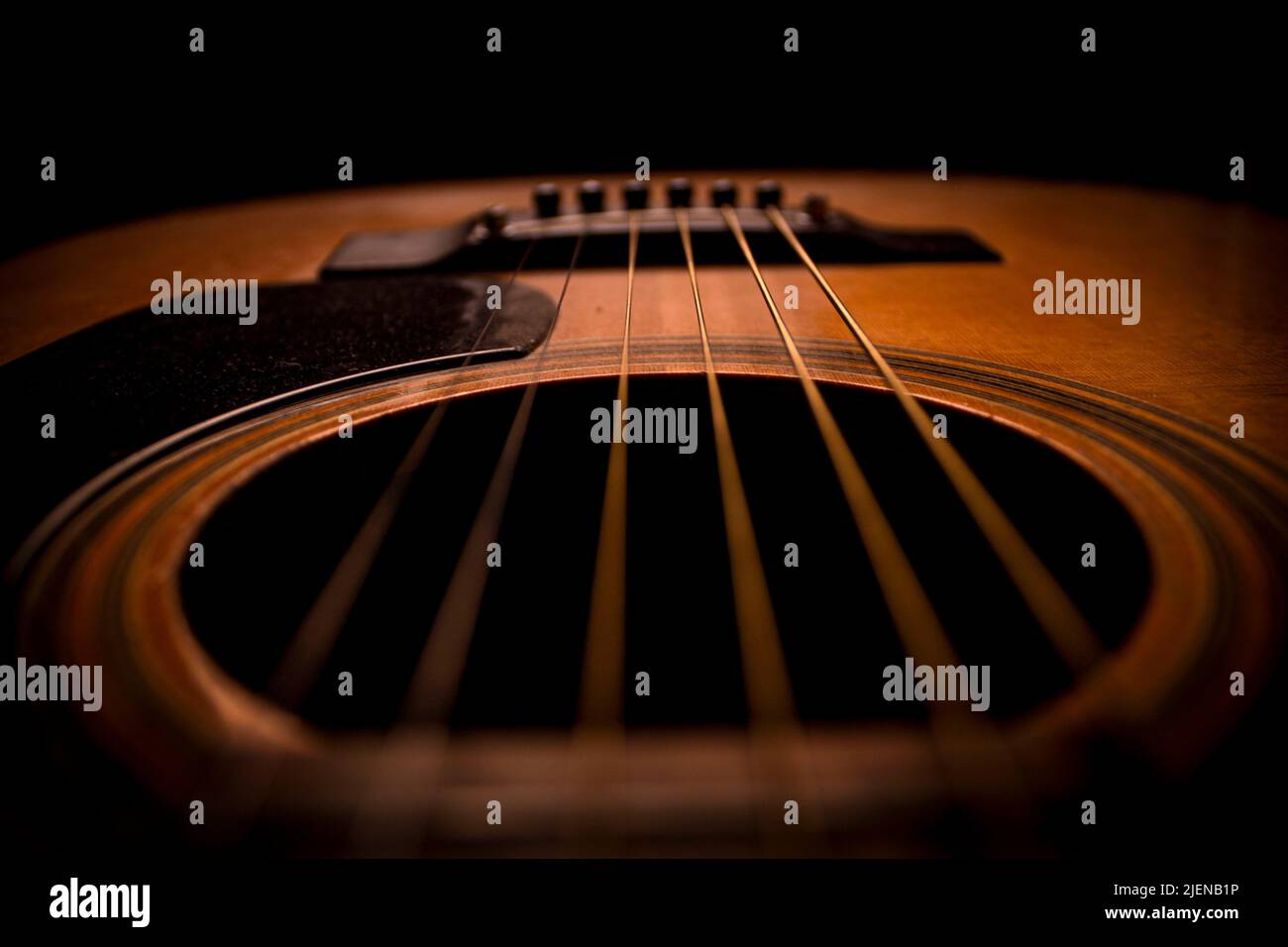 Guitar.Guitar's chords.Acoustic guitar.Music.Music background.Image of an acoustic guitar in the dark.Playing guitar music. Acoustic guitar chords. Stock Photo