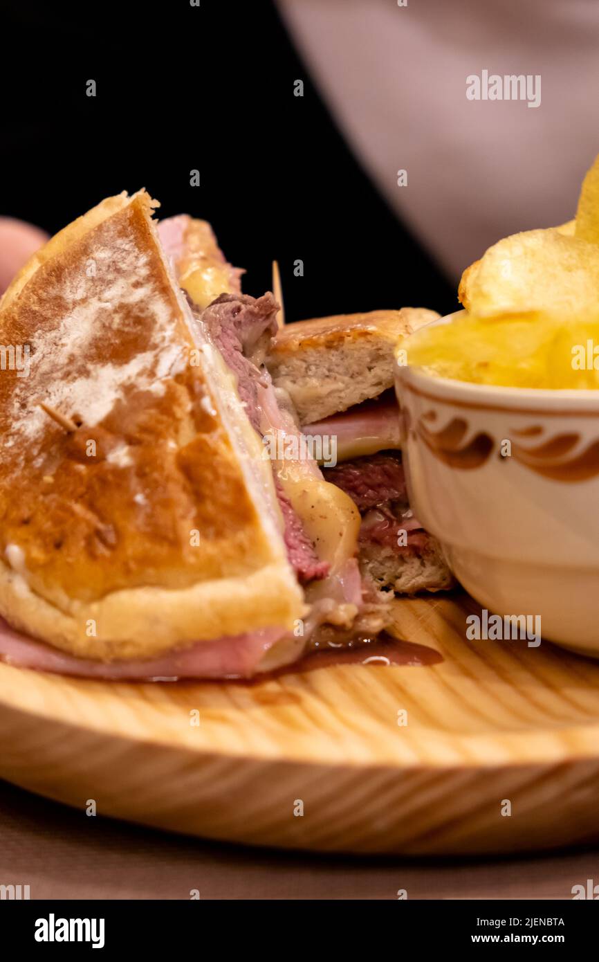 Delicious ham and cheese sandwich on yeast cake. Sandwich with cheese melting. Stock Photo