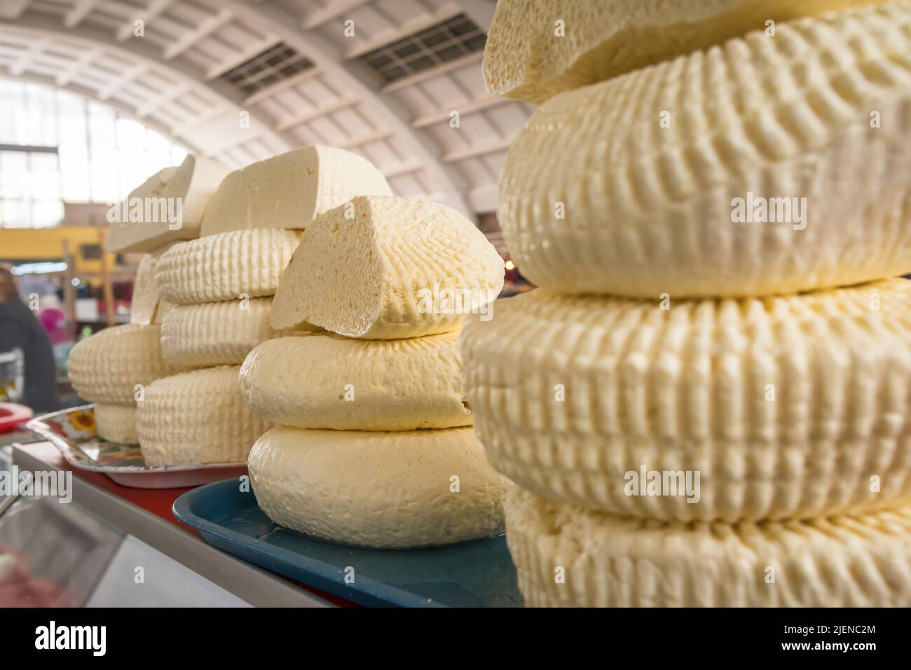 Closeup of piles of round homemade traditional cheese in the market in Georgia Stock Photo