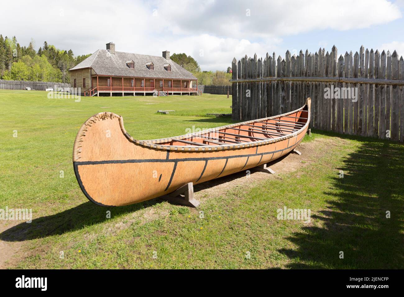 A replica a voyageur fur trading canoe and the Great Hall at the historic North West Company Grand Portage National Monument depot Stock Photo