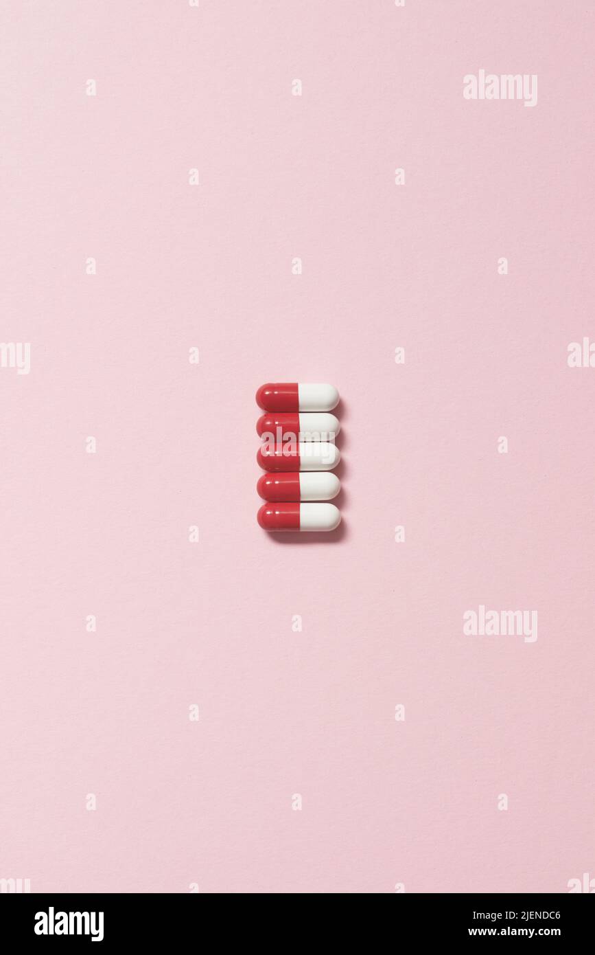 Pharmaceutical capsules over pink background Stock Photo - Alamy