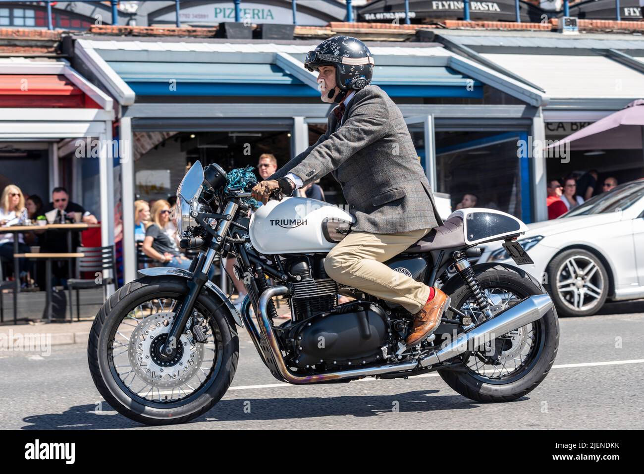 Motorcyclist taking part in the Distinguished Gentleman's Ride motorbike event, riding a Triumph Thruxton Stock Photo