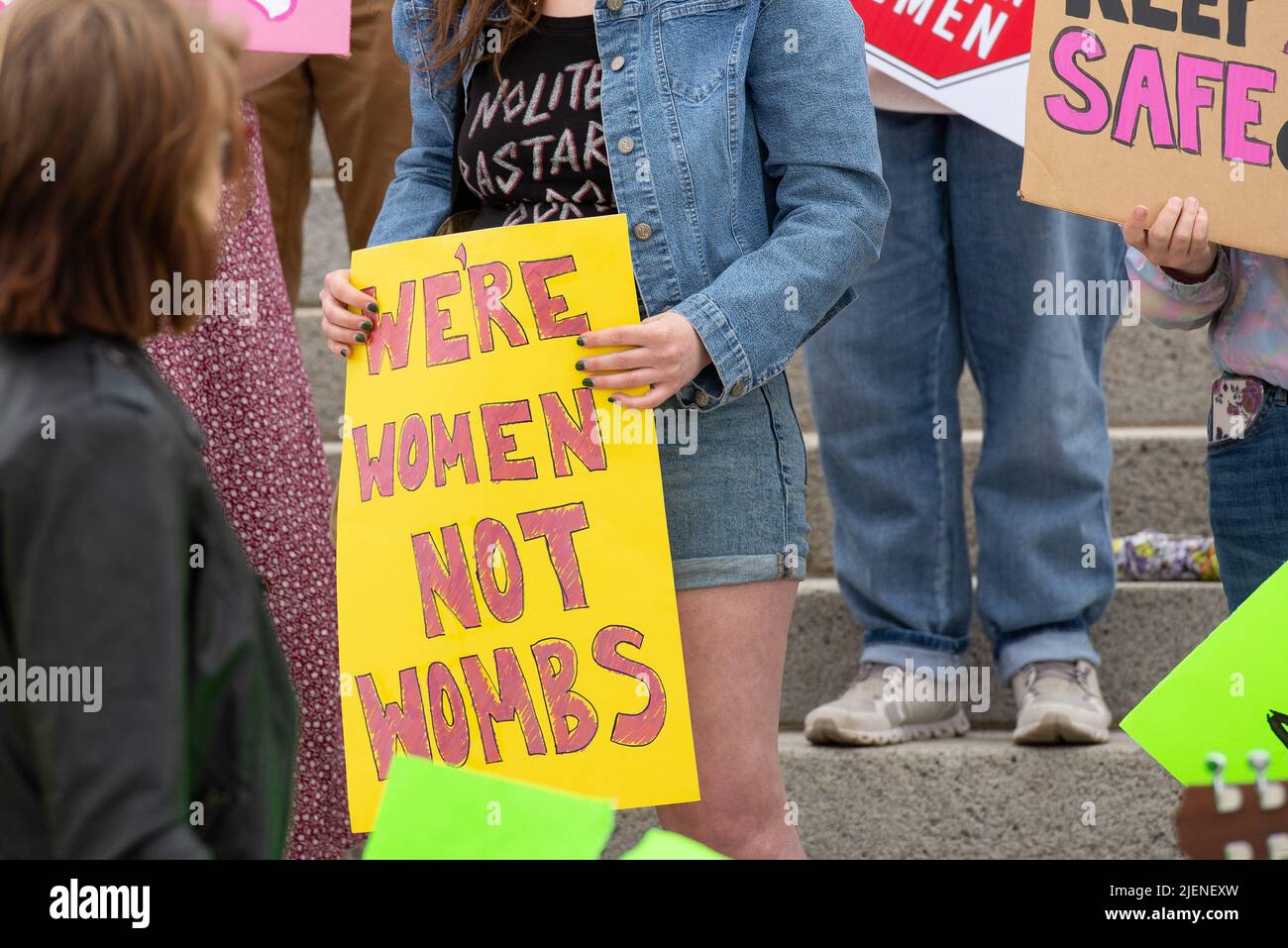 Helena, Montana - June 24, 2022: woman holds we're women not wombs sign protesting abortion ban, pro choice protest at Montana state capitol, demonstr Stock Photo