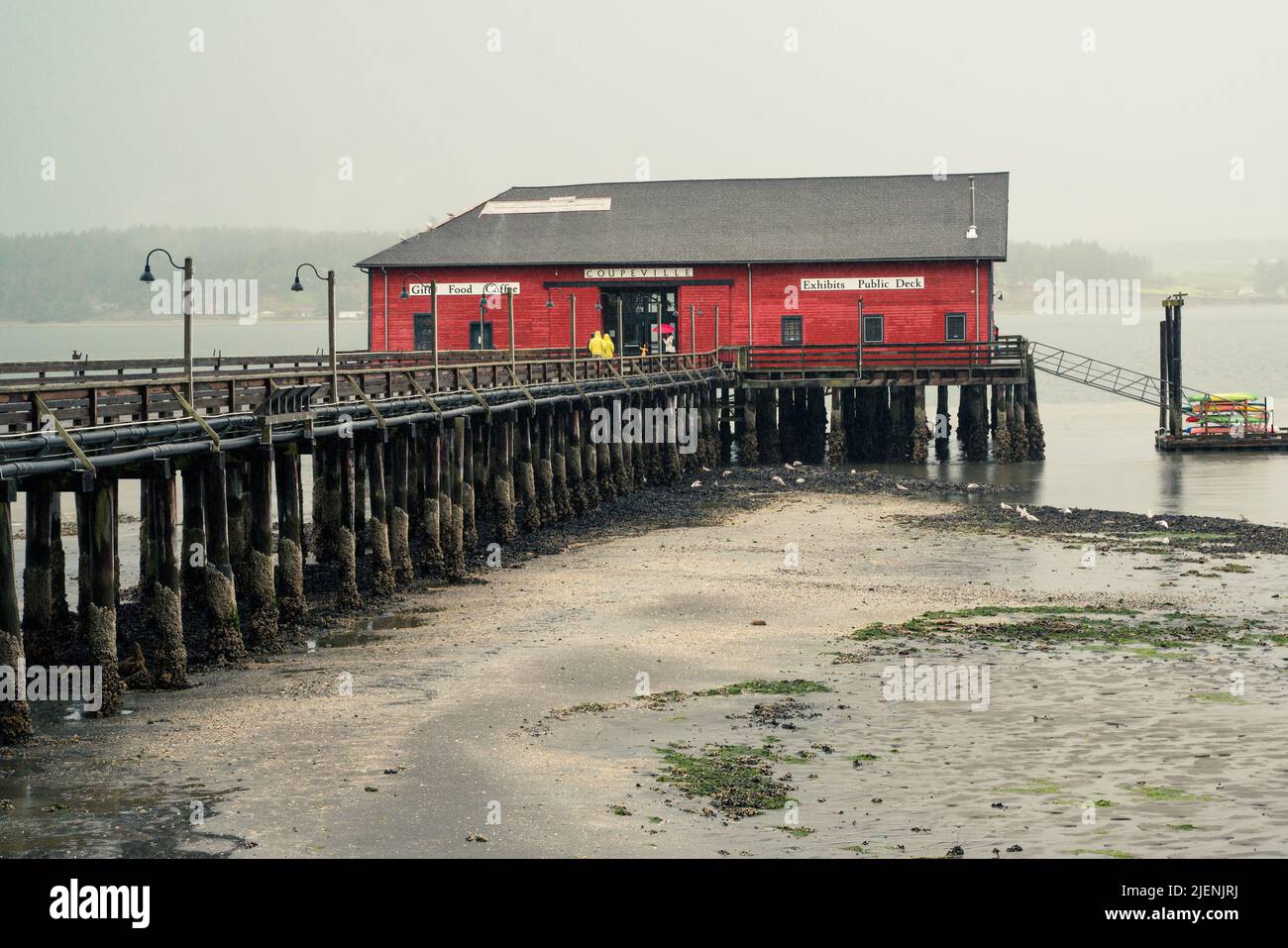 View from Coupeville Washington on Whidbey Island with pier and historic building in view, on a rainy day Stock Photo