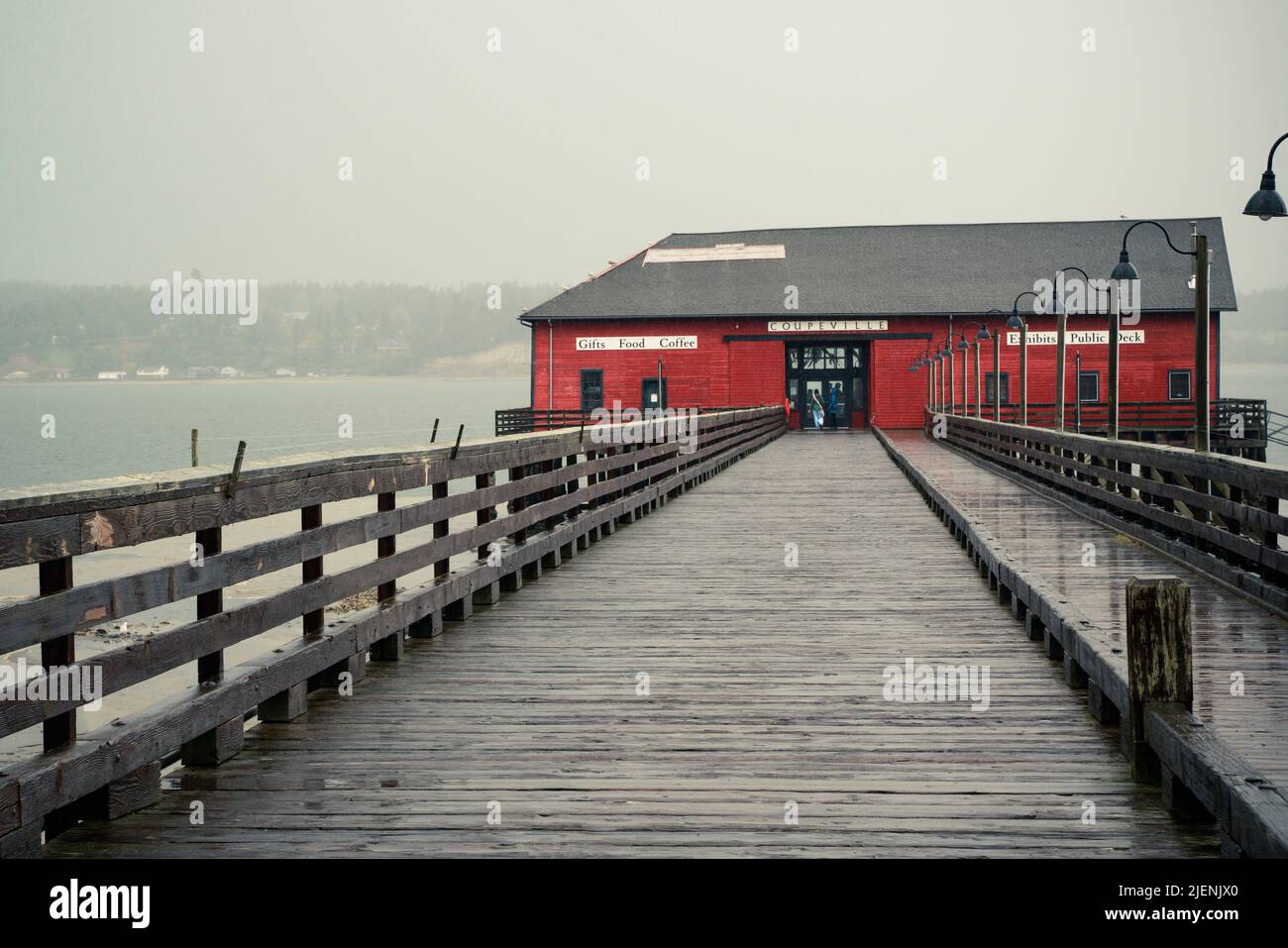 View from Coupeville Washington on Whidbey Island with pier and historic building in view, on a rainy day Stock Photo