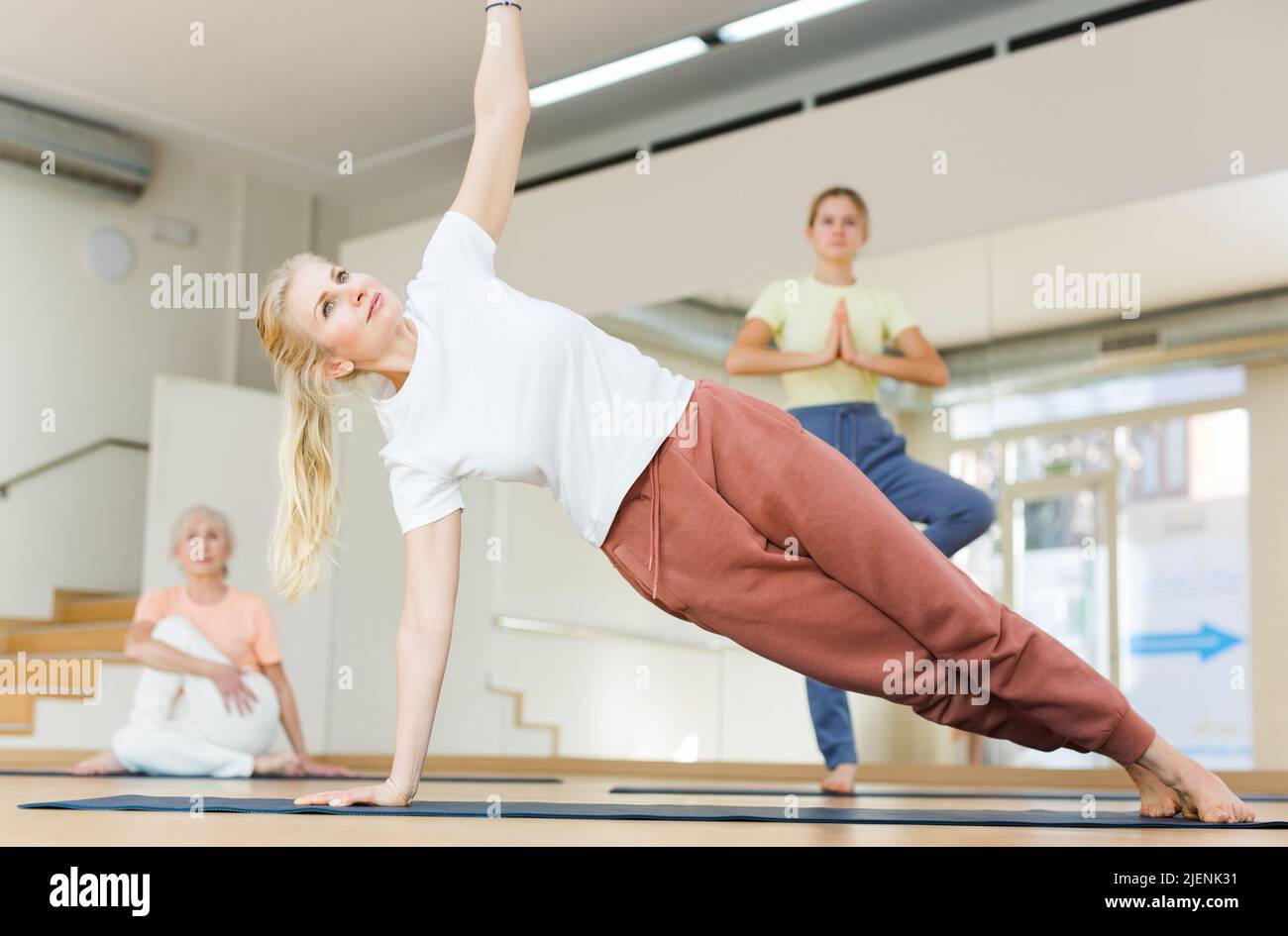 Woman practicing yoga in studio Stock Photo