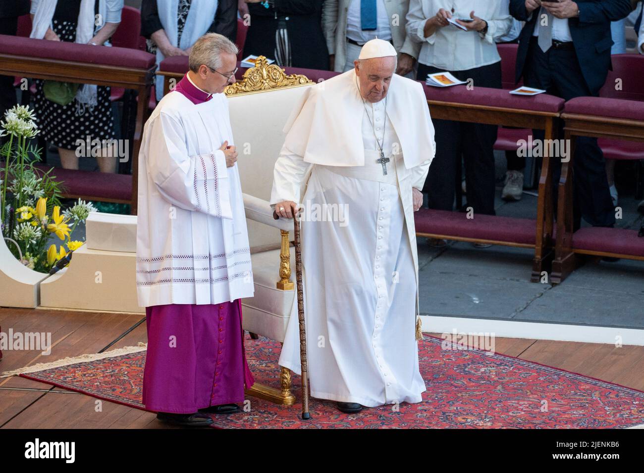Pope Francis is helped to stand with the use of his walking stick.Pope  Francis presides over a Holy Mass celebrated for participating in the X  World Meeting of Families in St. Peter's