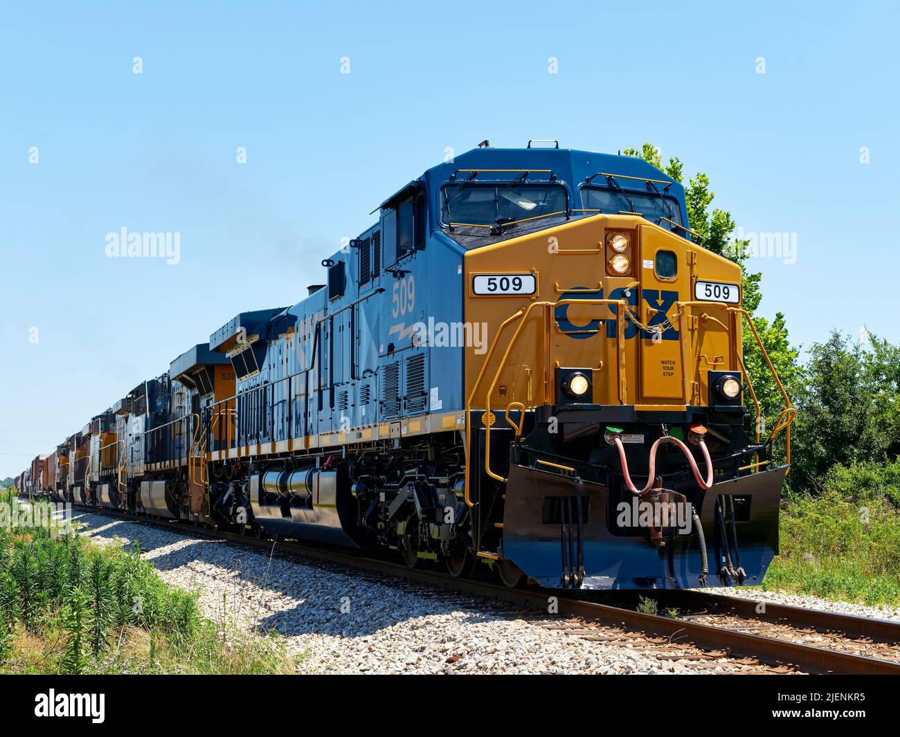 CSX Transportation #345, a GE AC4400CW diesel locomotive, leads additional locomotives pulling freight in Montgomery Alabama, USA. Stock Photo