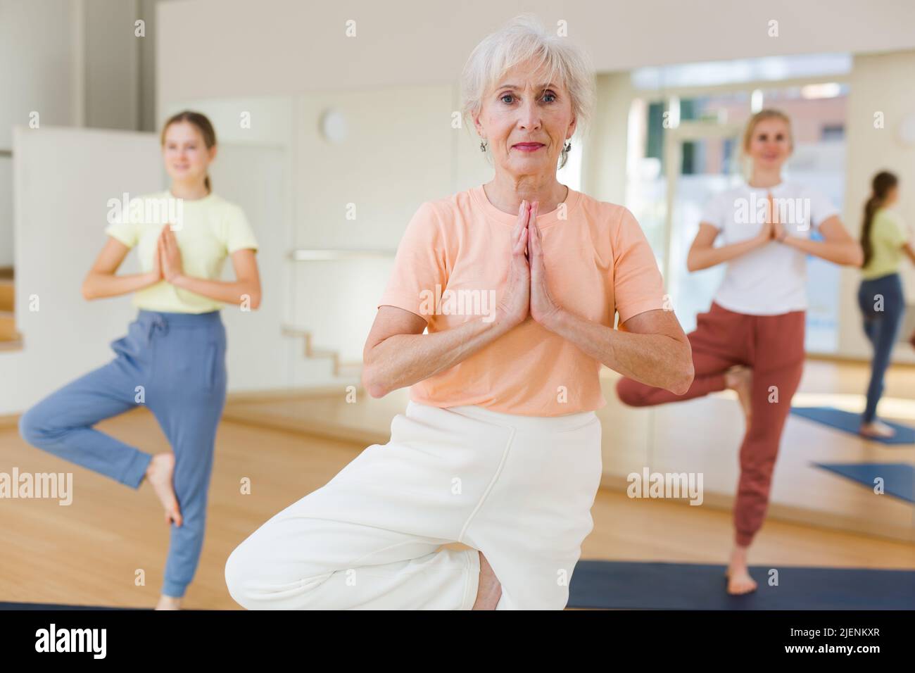 Senior woman exercising stretching workout Stock Photo - Alamy