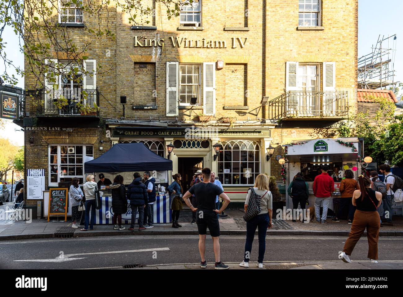 People outside the King William IV pub on Hampstead High Street, waiting to be served at the competing creperies Stock Photo