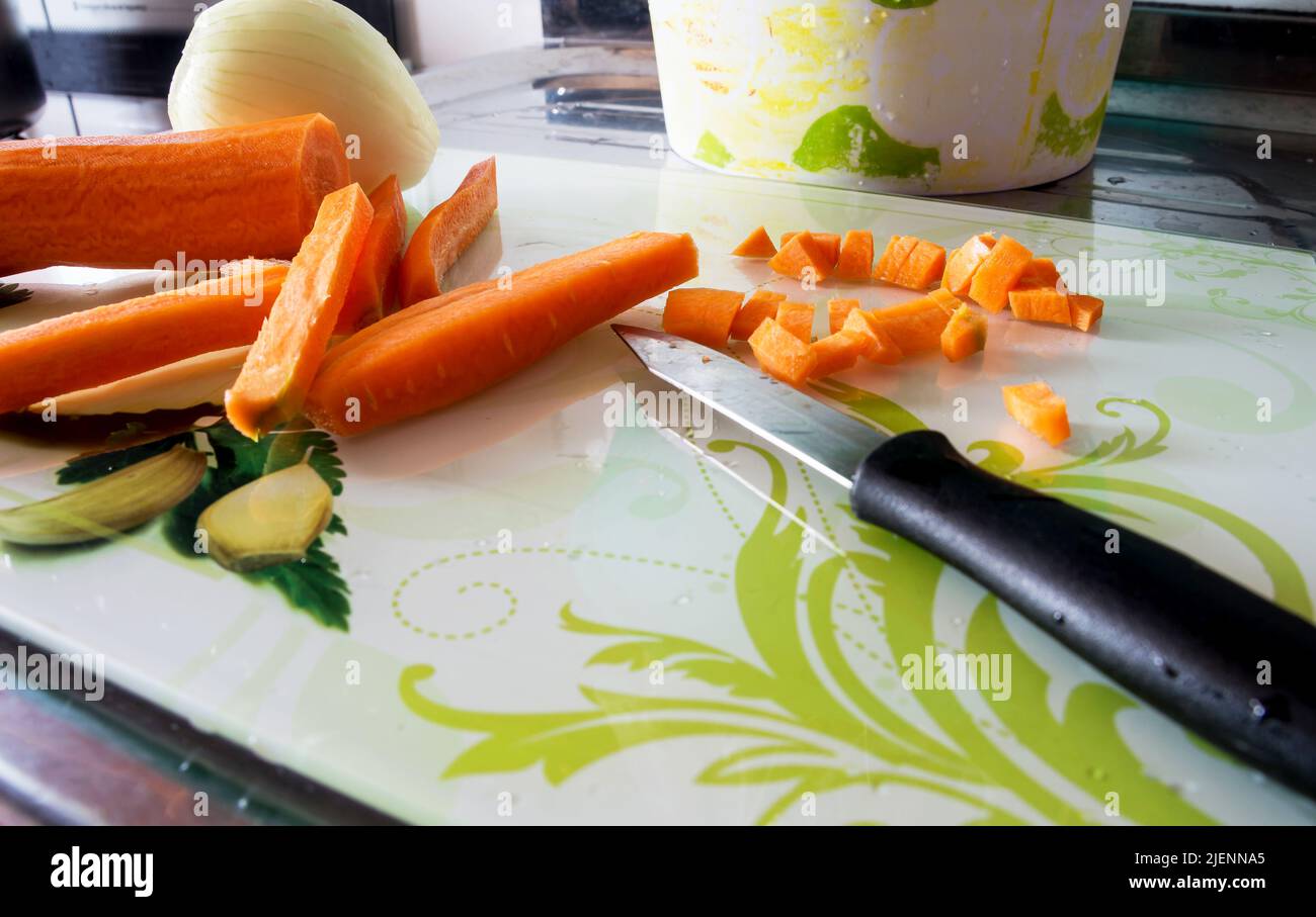 Raw carrots chopped into small pieces and into strips with onion and ...