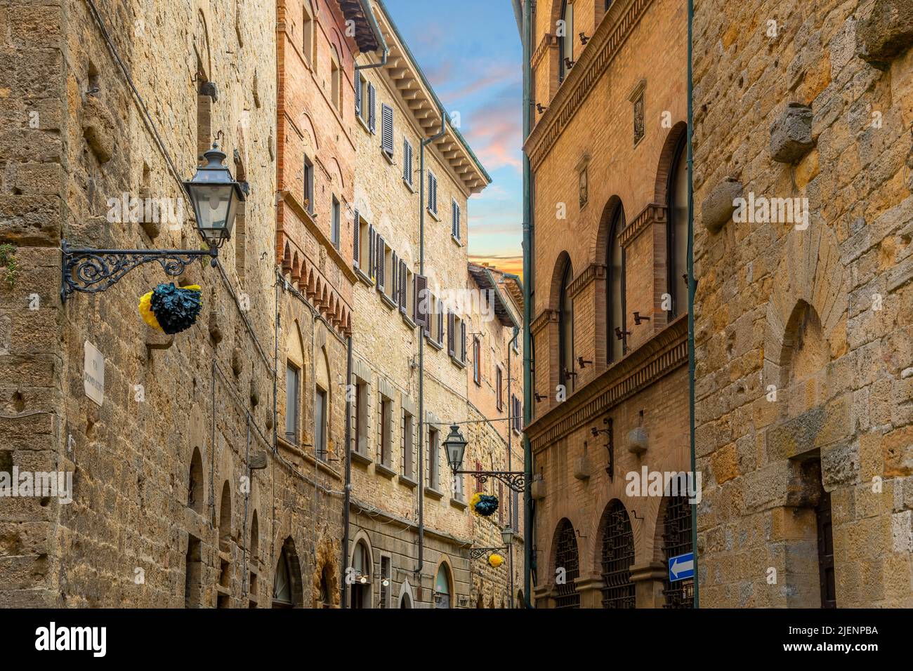 A picturesque street of homes and apartments in the historic medieval hill town of Volterra, Italy, in the Tuscany region. Stock Photo