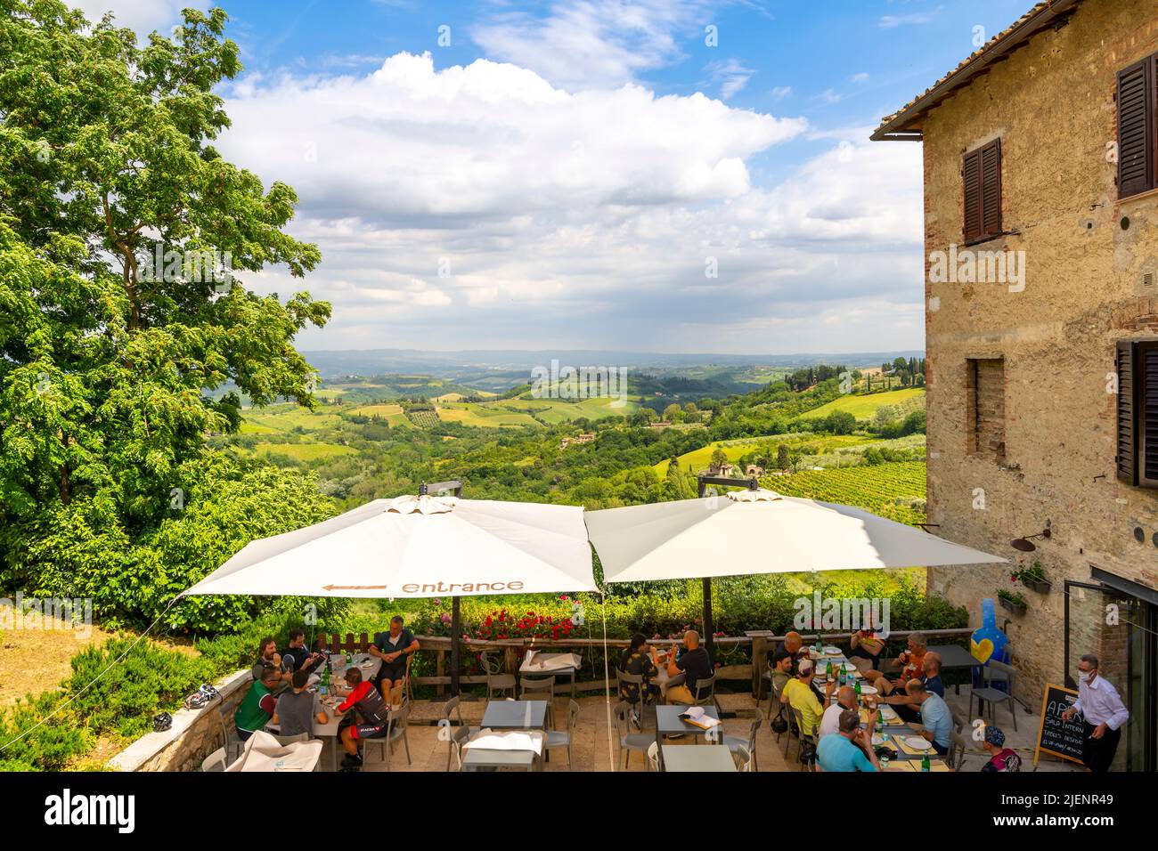 A picturesque cafe overlooking the hills and countryside of Tuscany in the hilltop town of San Gimignano, Italy. Stock Photo
