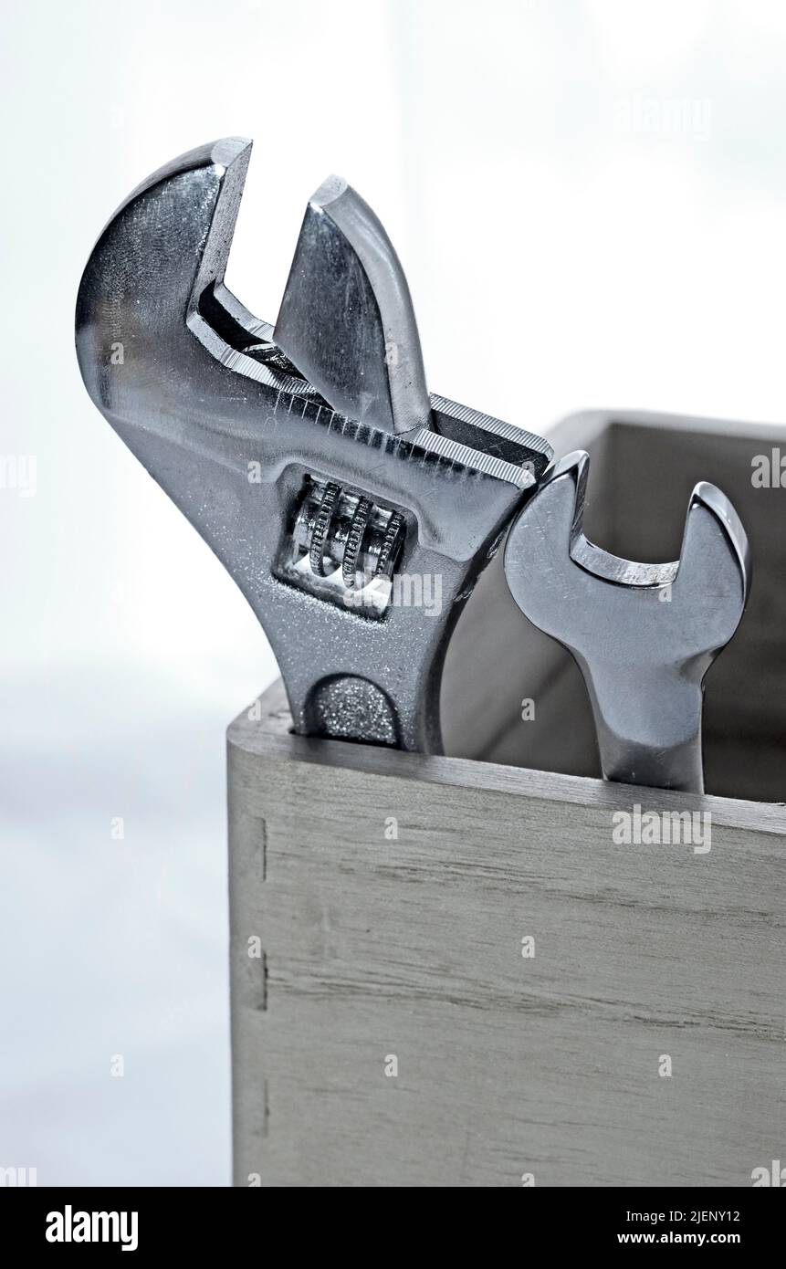 one small wrench and one adjustable wrench in wooden box Stock Photo